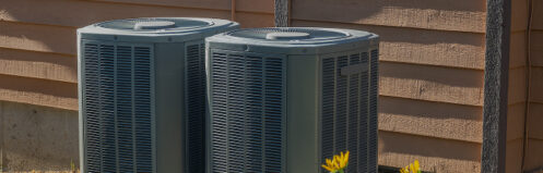 Outdoor air conditioning units sitting side-by-side in Central Wisconsin
