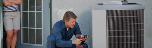 Technician repairing an AC unit in Central Wisconsin